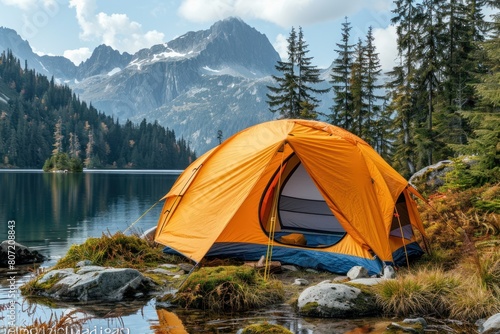A tent is set up on the shore of a lake