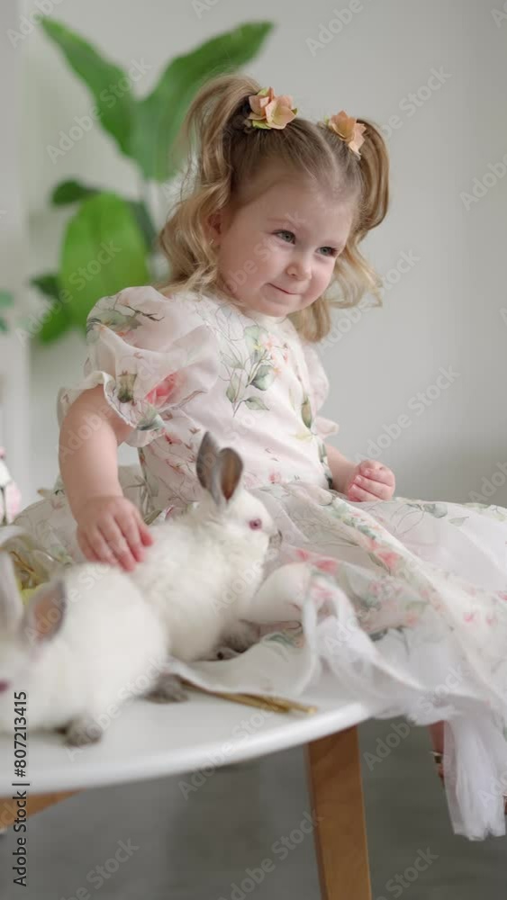 Cute little girl petting Easter bunny. Cute little girl petting Easter bunny.