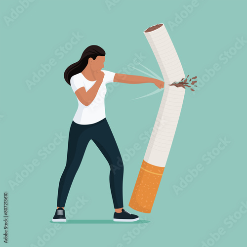 Woman punching a cigarette and fighting smoke addiction
