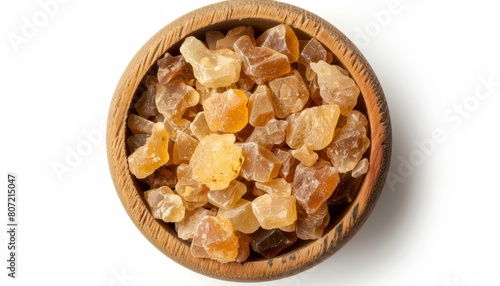 Frankincense tears olibanum resin in wooden bowl Aromatic resin from Boswellia trees Displayed on white background photo