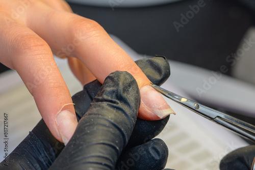Close-up manicure process  female hands painting nails