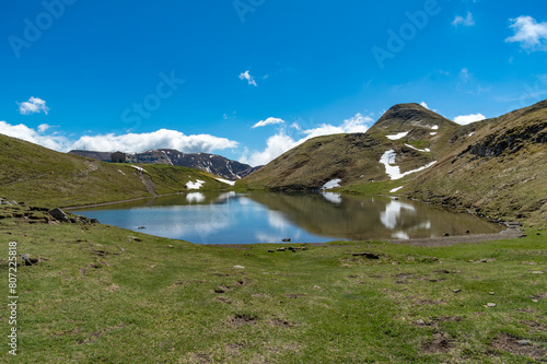 Il lago Scaffaiolo e i suoi riflessi a maggio photo