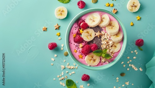 Minimal composition of healthy breakfast featuring a smoothie or asai bowl on a mint background adorned with berries bananas oatmeal dragon fruit stars and chi photo