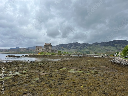 Ancient castle overlooks the waterfront from a hilltop in Scotland photo