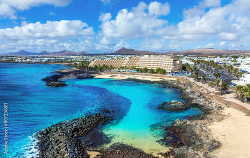 Aerial view of the famous El Jablillo beach resort on the Atlantic Coast of Lanzarote island with its blue crystal clear waters in the summer season. © cristianbalate