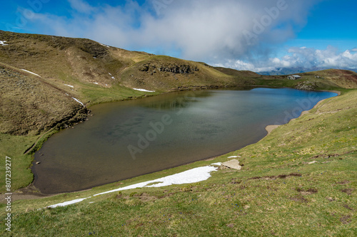 Il lago Scaffaiolo e i suoi riflessi a maggio photo