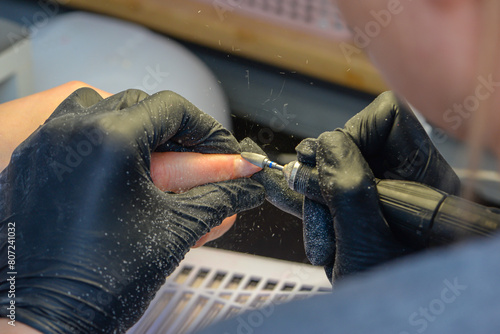 Close-up manicure process, female hands painting nails