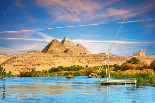 View on the Nile and the boats in the Aswan desert by the pyramids, Egypt