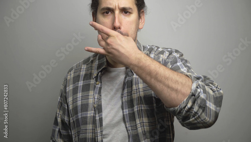 Canvas Print Angry young male whistling with fingers