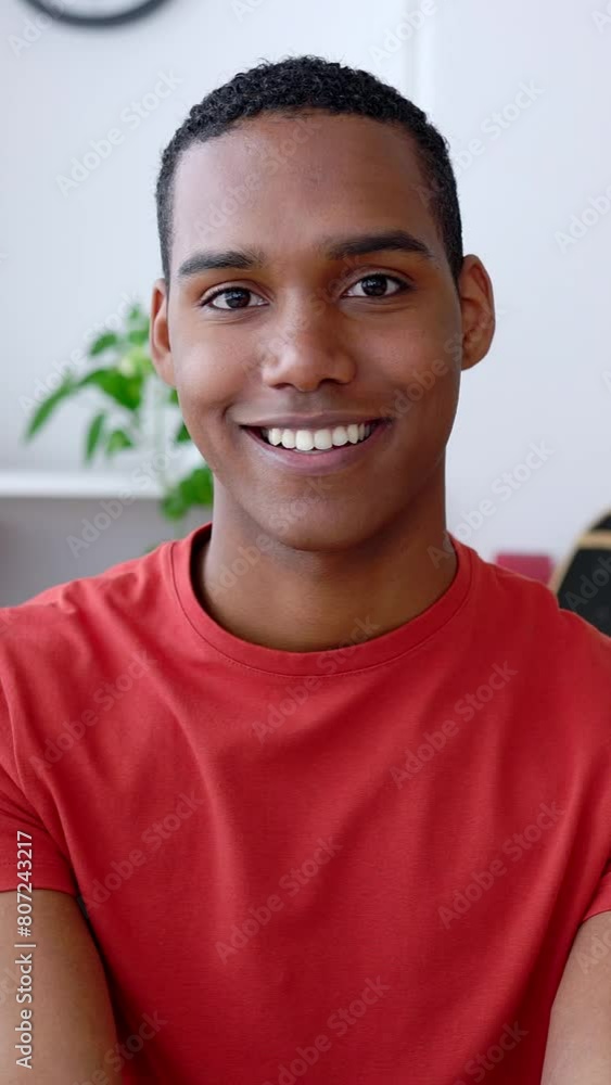 Close up vertical portrait of young joyful African American man smiling at camera on video call meeting from home. Happy people concept. HD screen video. Close up vertical portrait of young joyful African American man smiling at camera on video call meeting from home. Happy people concept. HD screen video.