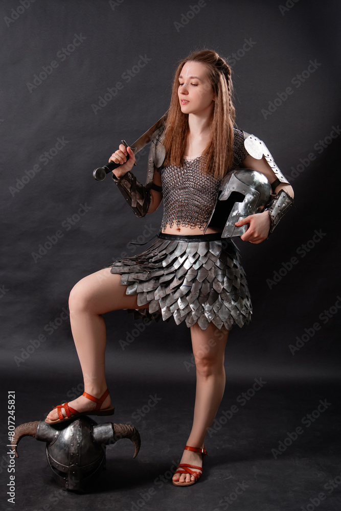 Full-length portrait of a medieval woman warrior in female armor with a ...