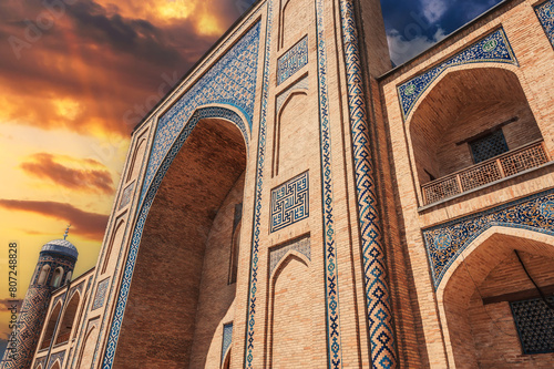 portal of the ancient medieval Uzbek Islamic Kukeldash madrasah in Tashkent in Uzbekistan. Old madrasa in Asia at sunset photo