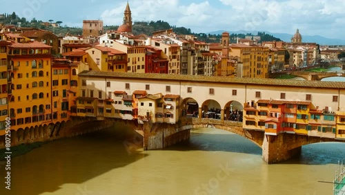Panoramic view of Ponte Vecchio in Florence, Tuscany, Italy, opened in 1345, spanning the Arno River featuring medieval market stalls photo