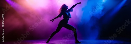 Silhouette of a female dancer expressing herself with dramatic poses against a backdrop of vivid stage lights