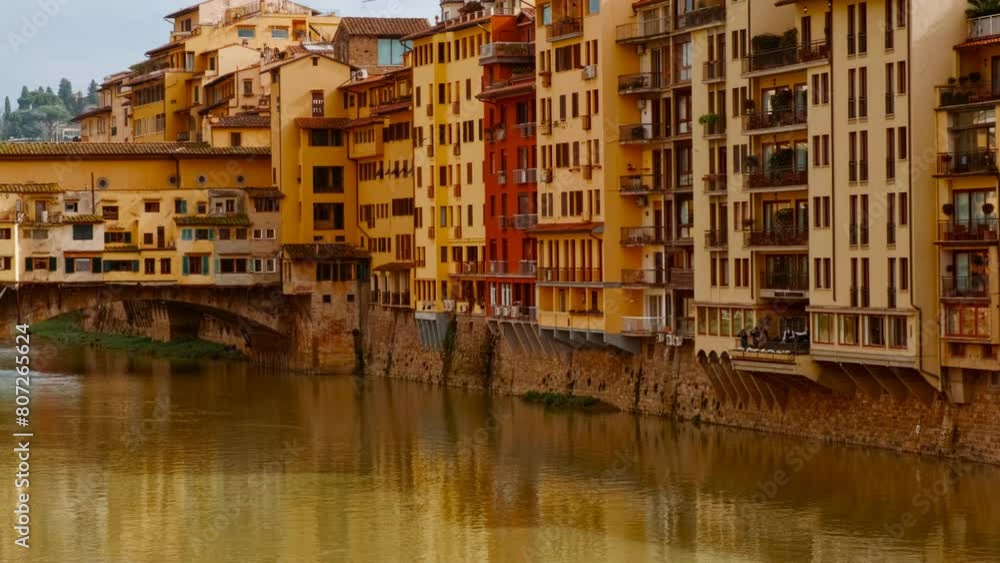 Panoramic view of Ponte Vecchio in Florence, opened in 1345, spanning the Arno River featuring medieval market stalls Panoramic view of Ponte Vecchio in Florence, opened in 1345, spanning the Arno River featuring medieval market stalls