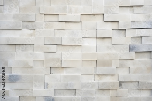 A wall of tiles with a white textured background.
