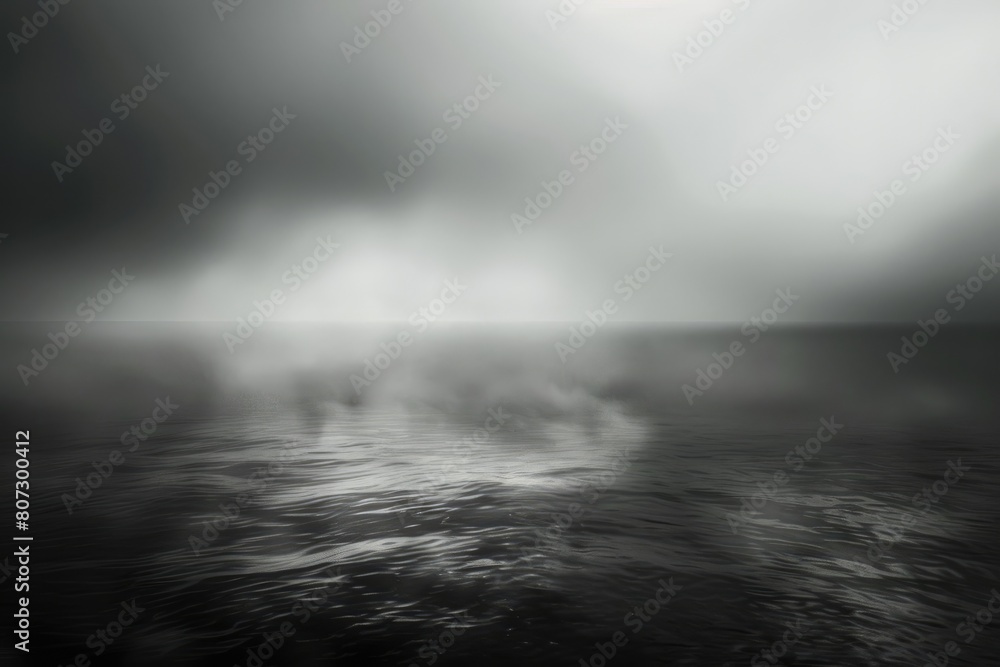 A grayscale photo of a calm sea on a foggy day. AIG51A.
