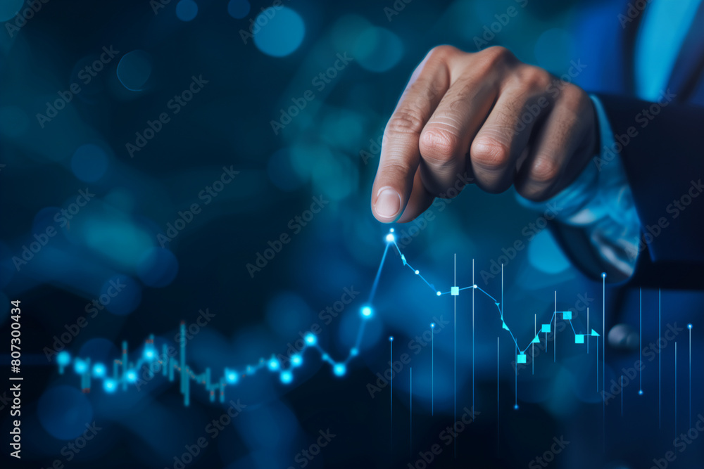 businessman hand pointing to stock market graph increase on blue background businessman hand pointing to stock market graph increase on blue background