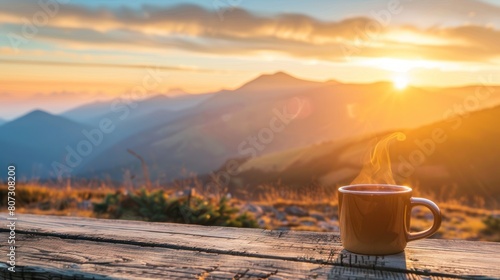 Morning cup of coffee with mountain background at sunrise photo