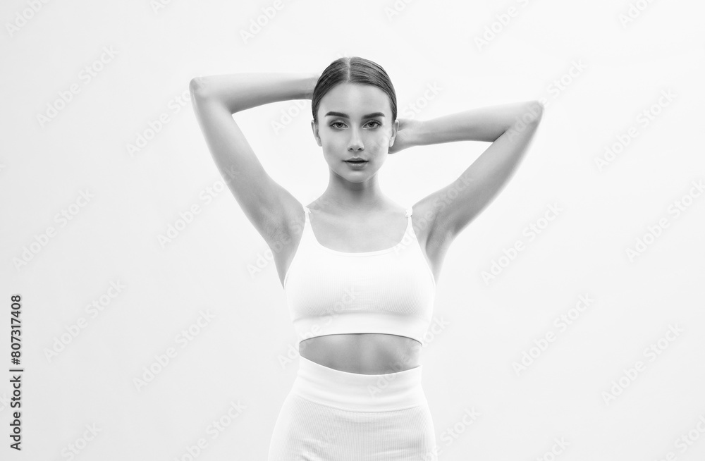 Obraz premium Beautiful attractive girl in white shorts and a top on a white background. The concept of sports and healthy lifestyle.