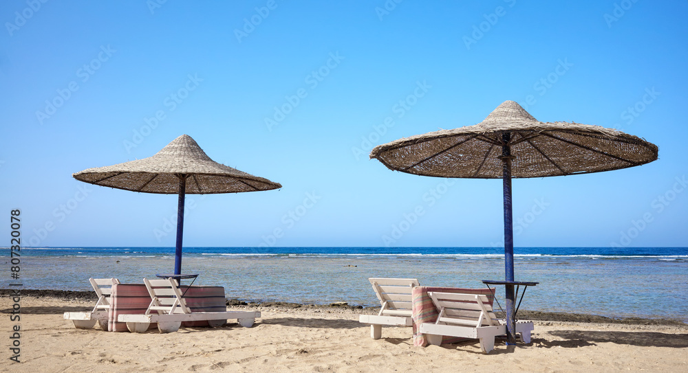 Beautiful sandy beach with sun loungers and umbrellas, Marsa Alam region, Egypt.