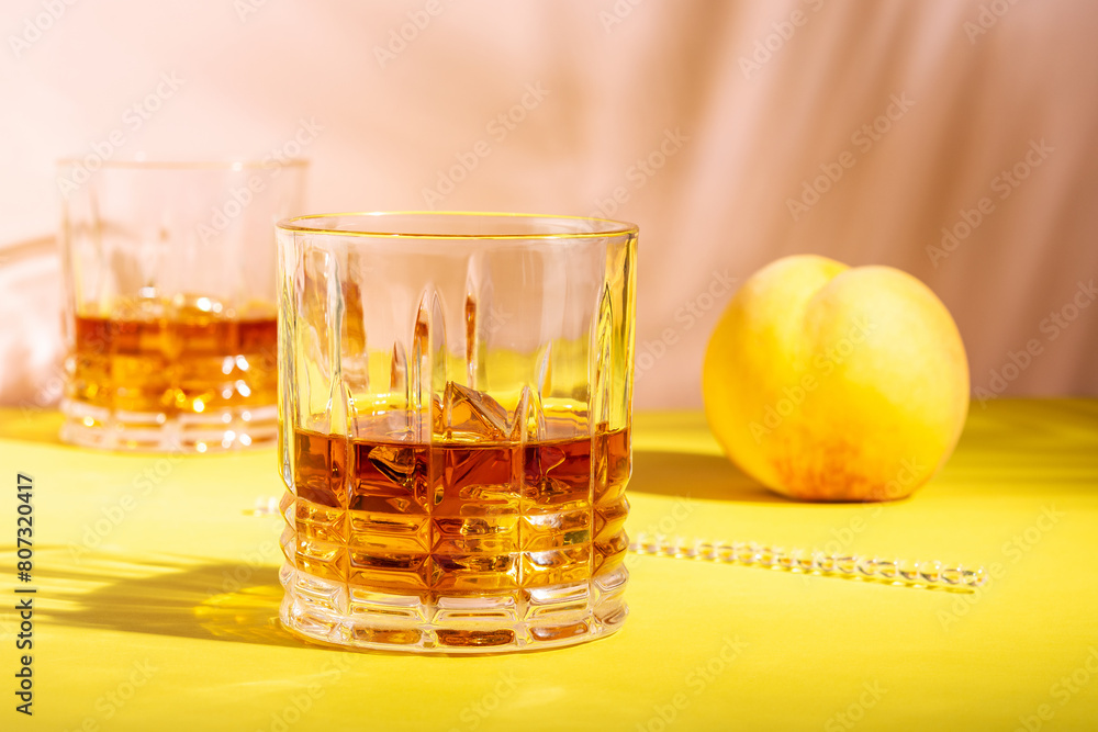 Rum or Amaretto sour with ice in a glass on a bright background. Summer party concept. Rum or Amaretto sour with ice in a glass on a bright background. Summer party concept.