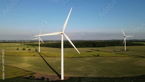 A Drone aerial view of Wind Farm featuring large wind generator turbines creating sustainable energy in England