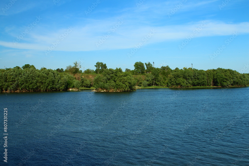 A body of water with trees in the background A body of water with trees in the background