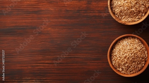 Brown rice grits in a wooden bowl on a wooden background. The concept of healthy eating. Rice porridge contains a large amount of vitamins and minerals.