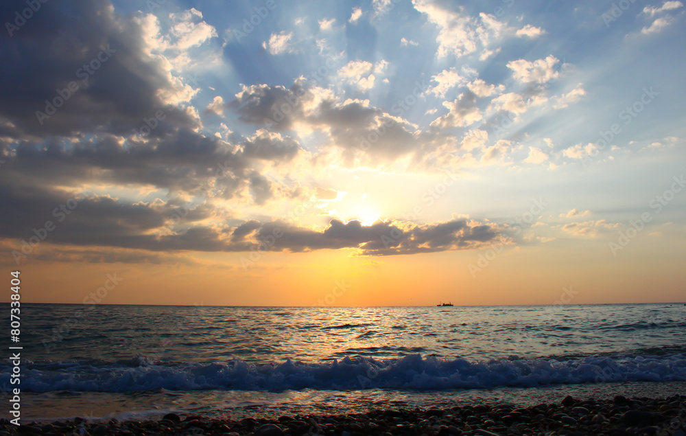 A beautiful sunset over the sea with orange clouds, and a calm tide A beautiful sunset over the sea with orange clouds, and a calm tide