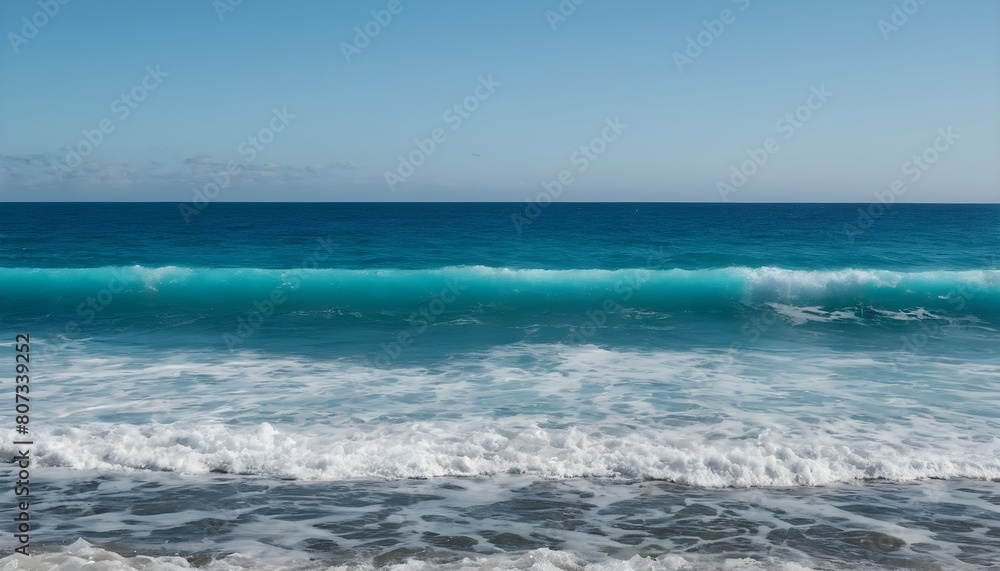 An ocean view with waves fading from azure blue to