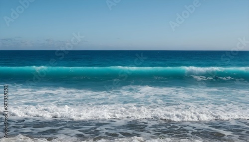 An ocean view with waves fading from azure blue to