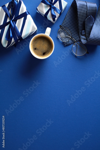 Happy Fathers Day vertical banner template. Flat lay vintage gift box, coffee cup, glasses on dark blue background. Top view, overhead.