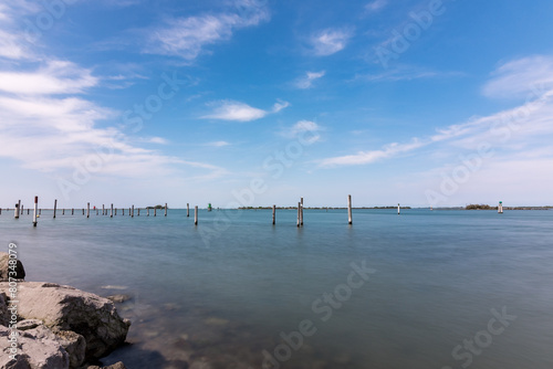 Panorama of the sky and sea in Grado, Italy with long exposure sunny day, view of the rocks. © Patrick