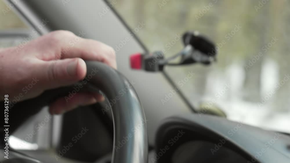 Close-up view from inside the car, the driver drives the car through the winter forest. Close-up view from inside the car, the driver drives the car through the winter forest.
