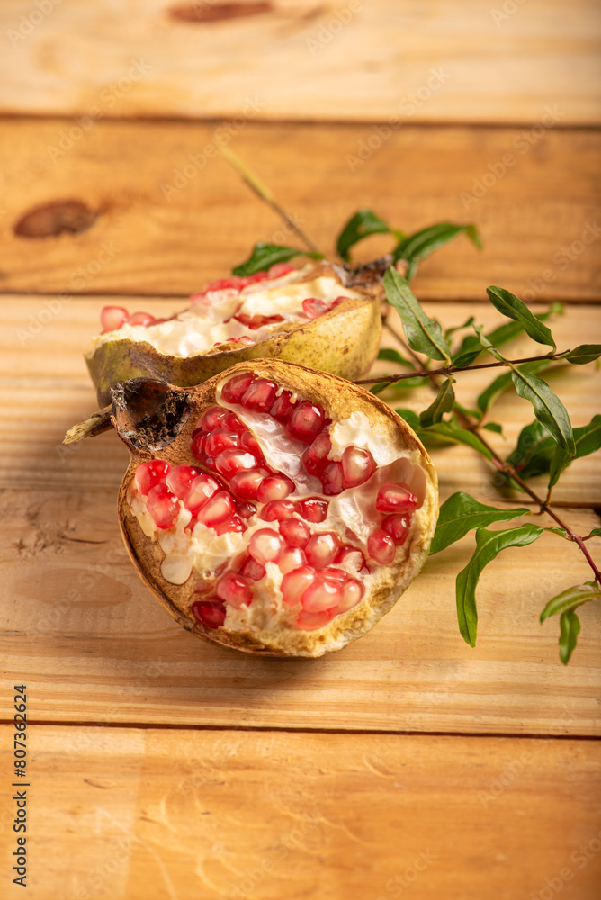 Pomegranate, a beautiful pomegranate on rustic wood, selective focus. Pomegranate, a beautiful pomegranate on rustic wood, selective focus.