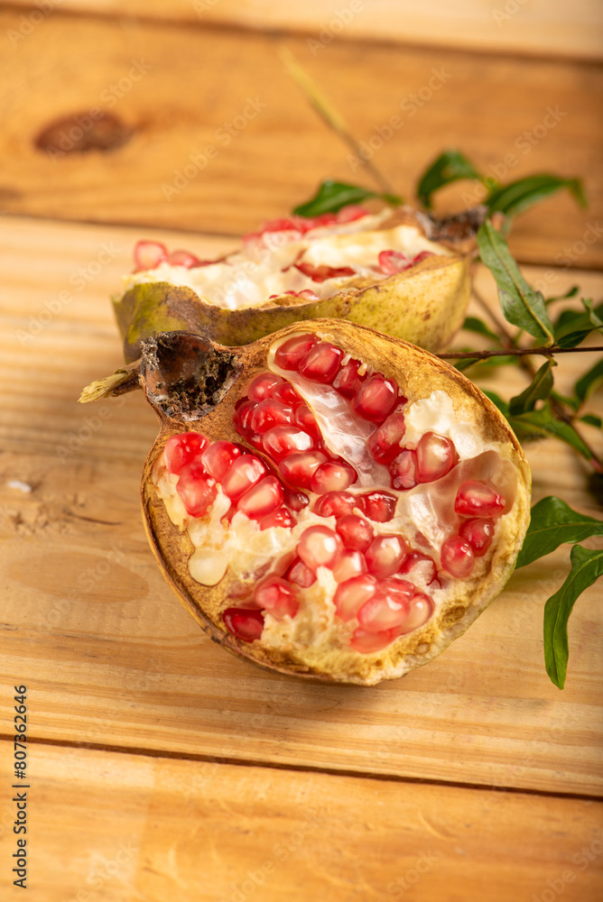 Pomegranate, a beautiful pomegranate on rustic wood, selective focus. Pomegranate, a beautiful pomegranate on rustic wood, selective focus.