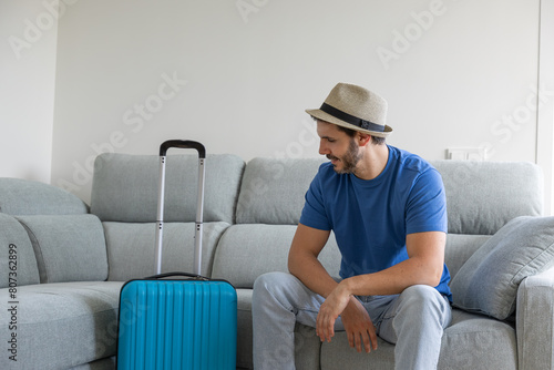 Happy man with suitcase prepared about to go on vacation © roberto