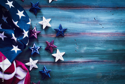 Fourth of July Background. American flag and red, white and blue stars over a rustic colorful wood table for Independence Day celebration with copy space. 