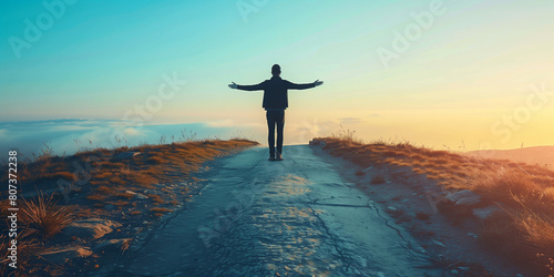  man with his back with his arms open to the landscape