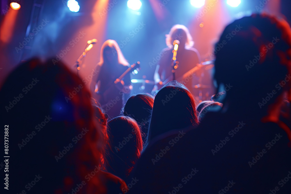 Concert Crowd. Silhouettes young people in front of bright stage lights. Band of rock stars
