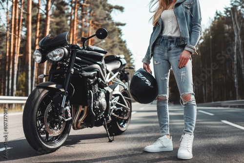 A woman standing next to a parked motorcycle. Suitable for transportation and lifestyle concepts