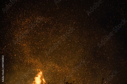 Fire embers particles over black background. Fire sparks background. Czech