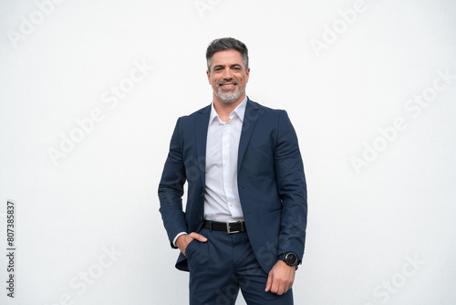 Confident portrait 40s mature successful businessman freelance entrepreneur in suit, copy space. Smiling senior business leader man standing proudly, looking at camera on isolated white background