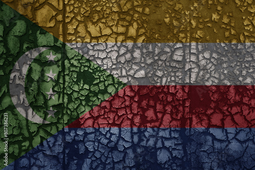 flag of comoros on a old grunge metal rusty cracked wall background
