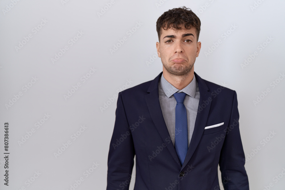 Young hispanic business man wearing suit and tie depressed and worry for distress, crying angry and afraid. sad expression. Young hispanic business man wearing suit and tie depressed and worry for distress, crying angry and afraid. sad expression.