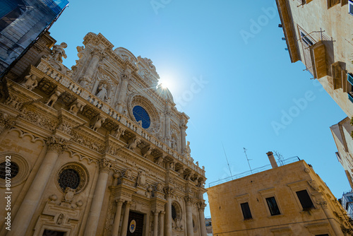 Basilica of holy cross or santa croce in central part of Lecce, Apulia, Italy. Beautiful basilica church lit by sun. Visible lens flare, outside view