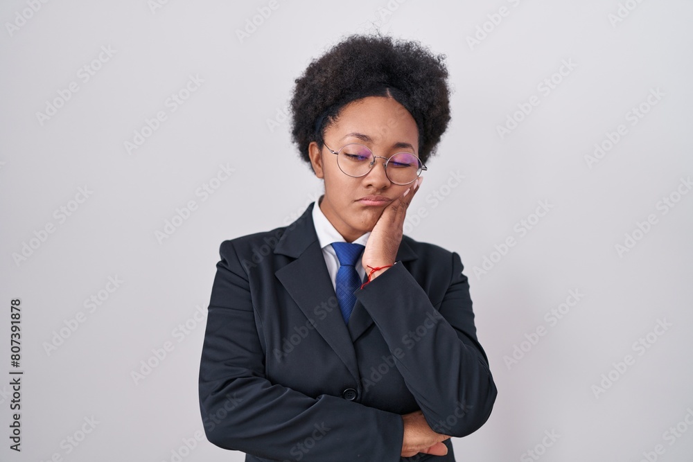 Beautiful african woman with curly hair wearing business jacket and glasses thinking looking tired and bored with depression problems with crossed arms. Beautiful african woman with curly hair wearing business jacket and glasses thinking looking tired and bored with depression problems with crossed arms.