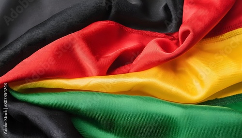 Black History Month banner, vibrant textile texture, red yellow green and black paint flag color background. Juneteenth Freedom Day Celebration, african liberation day concept