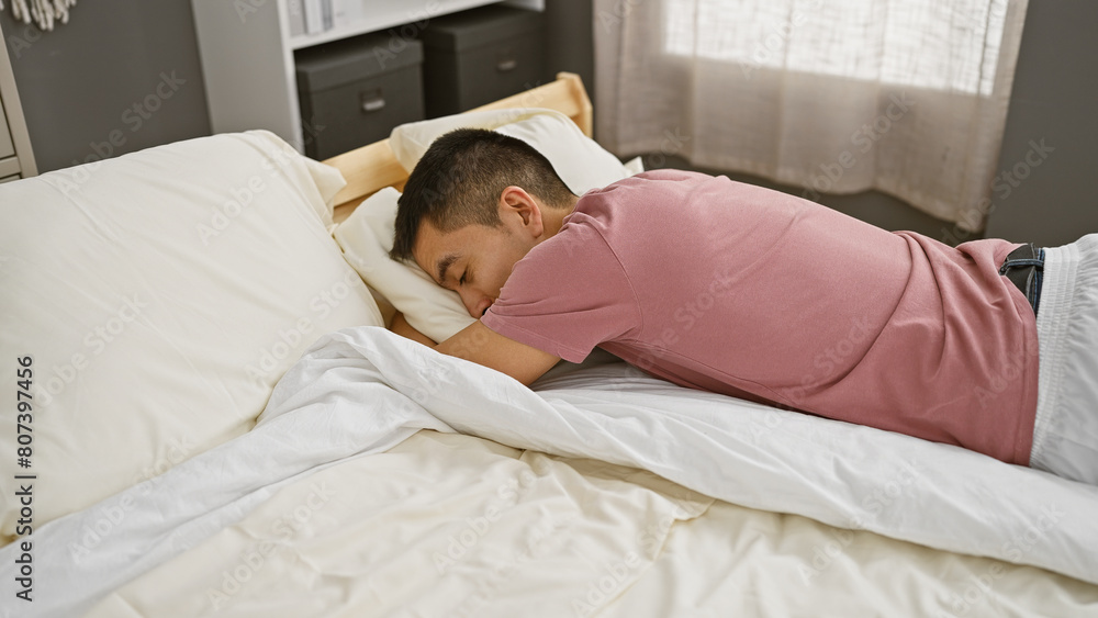 A young hispanic man sleeps peacefully in a cozy bedroom setting, evoking a sense of relaxation and domestic comfort. A young hispanic man sleeps peacefully in a cozy bedroom setting, evoking a sense of relaxation and domestic comfort.
